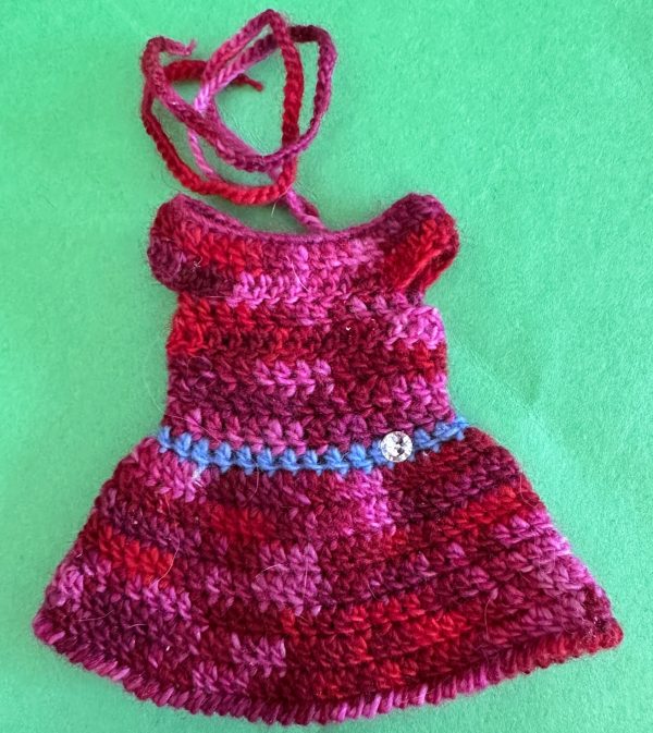 Crochet dress:  Reds & Pinks with rhinestone on blue crochet belt 3" neckline to hem. Hand crocheted
