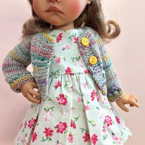 Outfit:  Includes hat, handmade multi-color sweater, floral print dress…fits 14-16″ dolls  (Model is Meadowdolls Moppet Tia)