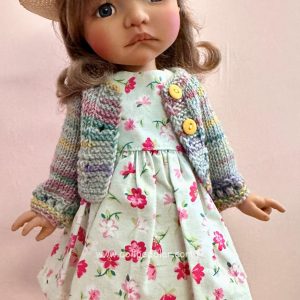 Outfit:  Includes hat, handmade multi-color sweater, floral print dress…fits 14-16″ dolls  (Model is Meadowdolls Moppet Tia)
